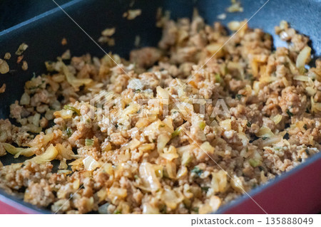 Minced meat dish being cooked in a frying pan 135888049