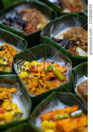 Indonesian Rice Meals Wrapped in Banana Leaf Indonesian Rice Meals Wrapped in Banana Leaf 135889014