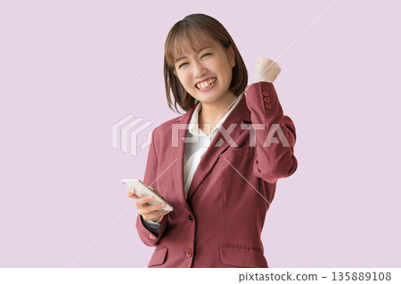 Business woman doing a fist pump Business woman doing a fist pump 135889108