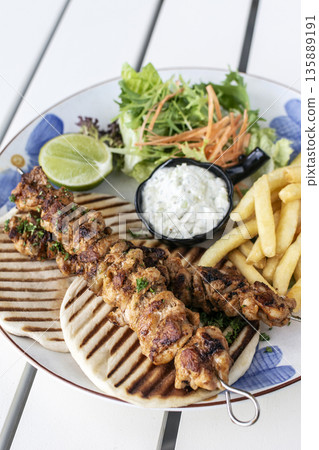 BBQ chicken skewer gyros plate on white table in mykonos  restaurant greece 135889191