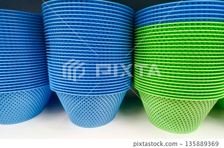 Stack of Blue and Green Round Plastic Drainer Baskets for Kitchen and Household Storage Use Stack of Blue and Green Round Plastic Drainer Baskets for Kitchen and Household Storage Use 135889369