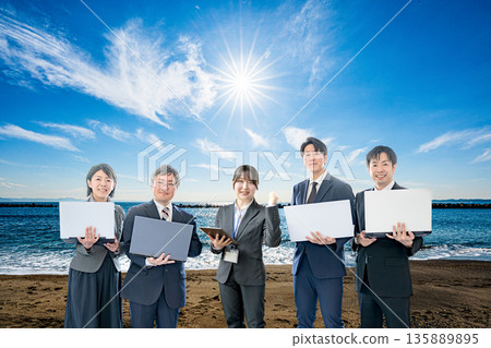 The sea, the sun and a professional business team 135889895