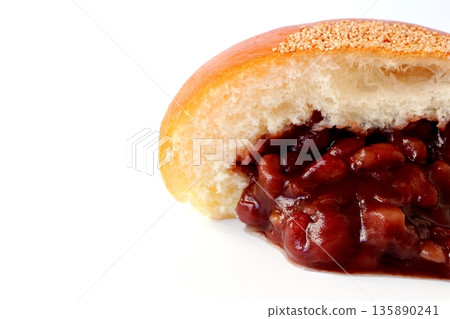 Cross section of anpan overflowing with red bean paste on a white background 135890241