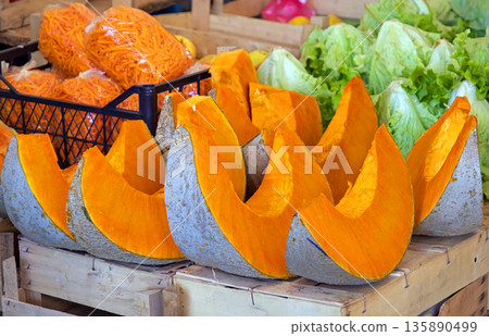 Sliced pumpkin sold on market stall 135890499
