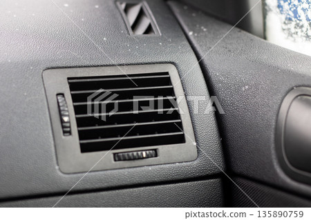 Detail shot of icy buildup on automobile dashboard and air vents during winter morning Detail shot of icy buildup on automobile dashboard and air vents during winter morning 135890759