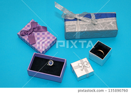 Open gift boxes with rings inside Open gift boxes with rings inside 135890760