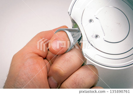 Opening metal can with hand 135890761