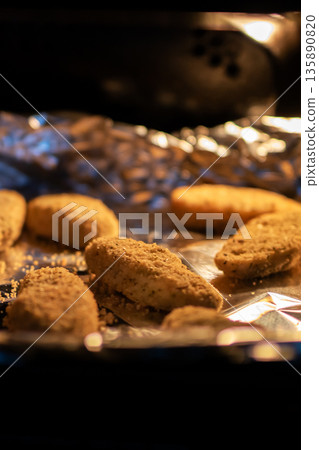 Delicious ovenroasted chicken nuggets with golden crust and inviting aroma for family meal 135890820