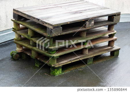 Dilapidated rooftop pallets, Abandoned weathered pallets atop city flat roofing surface 135890844
