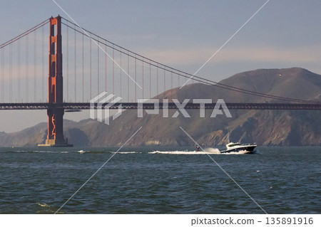 Golden Gate Bridge with fast boat on ocean Golden Gate Bridge with fast boat on ocean 135891916
