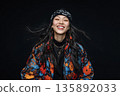 AI-generated photo: A young woman wearing a cap and flashy clothing with flowing hair against a black background 135892033