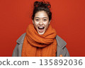 AI-generated photo: A smiling young woman wearing a scarf against a red background 135892036