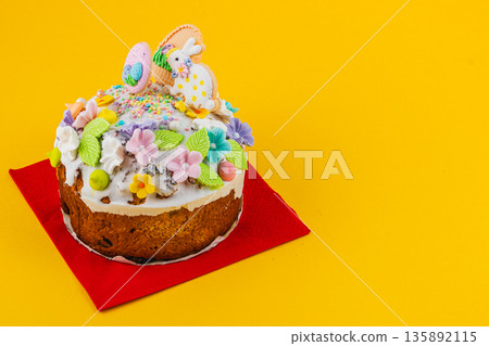 Bunny cake on a red napkin against a yellow background 135892115