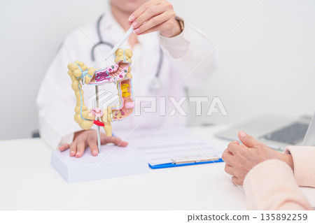 Elderly woman Patient consultation with doctor for Colon disease, Large Intestine, Colorectal cancer, Ulcerative colitis, Diverticulitis, Irritable bowel syndrome, Digestive system and Healthcare 135892259
