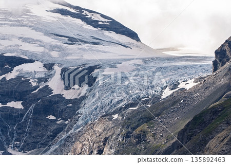 Majestic Glacier Landscape Awe-Inspiring Mountain Ice Formation under Cloudy Skies Majestic Glacier Landscape Awe-Inspiring Mountain Ice Formation under Cloudy Skies 135892463