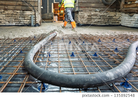 Concrete Slab Pouring with Rebar and Vapor Barrier in Building Construction Site Concrete Slab Pouring with Rebar and Vapor Barrier in Building Construction Site 135892548