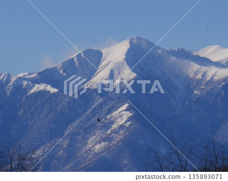 The majestic snow-capped peaks of the Northern Alps towering against the clear winter sky. January 29, 2015 Matsumoto City, Nagano Prefecture, Japan The majestic snow-capped peaks of the Northern Alps towering against the clear winter sky. January 29, 2015 Matsumoto City, Nagano Prefecture, Japan 135893071