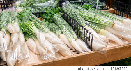 Close-up of bagged radishes lined up at a farmer's market Close-up of bagged radishes lined up at a farmer's market 135893311