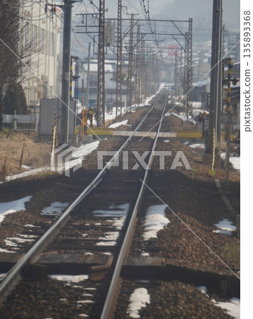 Snow-covered railway tracks in winter in Shinshu and the scenery stretching into the distance. January 2015, Nagano Prefecture Snow-covered railway tracks in winter in Shinshu and the scenery stretching into the distance. January 2015, Nagano Prefecture 135893368