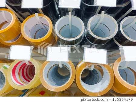 Various Adhesive Tape Rolls on Display Rack for Packing and Household Maintenance Repairs Various Adhesive Tape Rolls on Display Rack for Packing and Household Maintenance Repairs 135894179