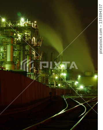 The fantastical Kawasaki industrial area's plants and smoke floating in the darkness of night. January 25, 2015 Kawasaki City, Japan The fantastical Kawasaki industrial area's plants and smoke floating in the darkness of night. January 25, 2015 Kawasaki City, Japan 135894337