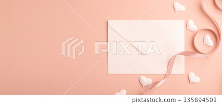 White envelope with ribbon and hearts on pastel background White envelope with ribbon and hearts on pastel background 135894501