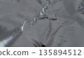 Light metallic foil texture with soft creases and abstract surface 135894512