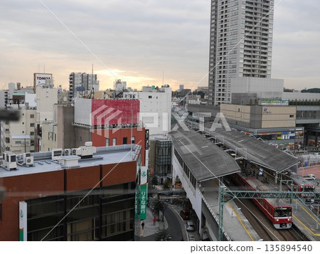 Keikyu Tsurumi Station platform and red train at dusk in winter, January 2015, Yokohama, Japan Keikyu Tsurumi Station platform and red train at dusk in winter, January 2015, Yokohama, Japan 135894540