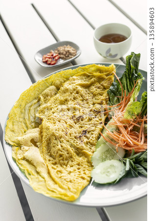 Banh xeo vietnamese traditional food pancake crepe with pork and salad in Vietnam Banh xeo vietnamese traditional food pancake crepe with pork and salad in Vietnam 135894603