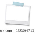 Polaroid photo frame secured with blue tape 135894713