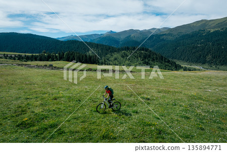 Riding mountain bike in the beautiful mountains Riding mountain bike in the beautiful mountains 135894771