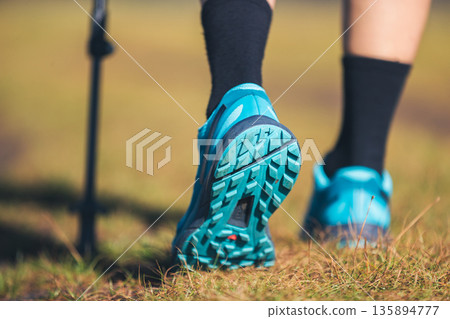 Fitness woman legs walking on high altitude grassland mountain road Fitness woman legs walking on high altitude grassland mountain road 135894777