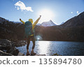 Backpacking woman enjoy the beautiful sunset landscape 135894780