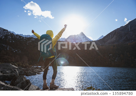 Backpacking woman enjoy the beautiful sunset landscape Backpacking woman enjoy the beautiful sunset landscape 135894780