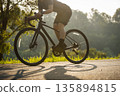 Cyclist riding bike at summer park 135894815
