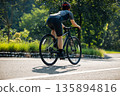 Cyclist riding bike at summer park 135894816