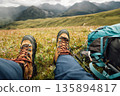 Woman backpacking on high altitude mountains top,sit on the grass 135894817