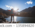 Happy backpacking woman photographer on autumn high altitude mountains 135894820