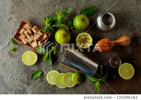 Wooden citrus squeezer, shaker, and ingredients for making summer refreshing drinks. 135896162