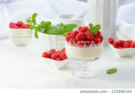 Panna cotta with fresh raspberries. 135896164