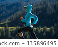 Fitness asian woman runner running at sunrise grassland 135896495