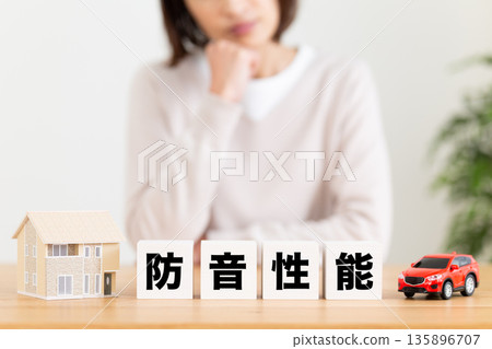 A middle-aged woman worries about soundproofing blocks A middle-aged woman worries about soundproofing blocks 135896707