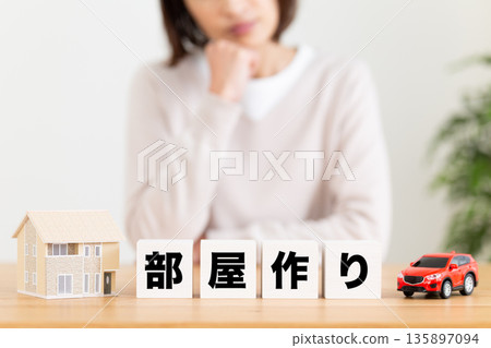 A middle-aged woman struggling with room construction blocks 135897094