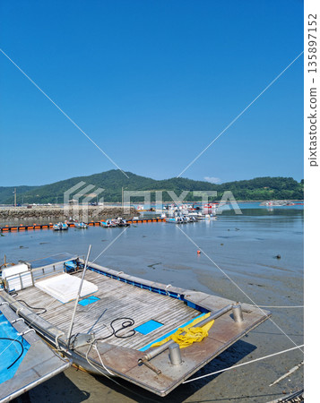 It is a fishing village scene with fishing boats. It is a fishing village scene with fishing boats. 135897152