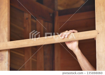 Asian man hand touch window frame Asian man hand touch window frame 135898060