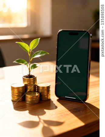 Financial Success Concept with Smartphone and Sprouting Plant on Gold Coins Stacks. Natural Sunlight on Wood Surface, Symbolizing Wealth, Sustainable Business, and Mobile Banking. Financial Success Concept with Smartphone and Sprouting Plant on Gold Coins Stacks. Natural Sunlight on Wood Surface, Symbolizing Wealth, Sustainable Business, and Mobile Banking. 135898508