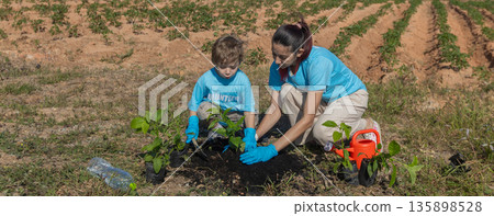 Family helping planting tree in garden for save world on wind turbine field background Family helping planting tree in garden for save world on wind turbine field background 135898528