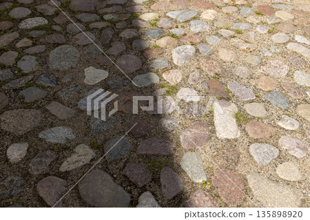 a road made of stones of different sizes in rural areas, a reconstructed ancient road made of multicolored stones, cobblestones a road made of stones of different sizes in rural areas, a reconstructed ancient road made of multicolored stones, cobblestones 135898920