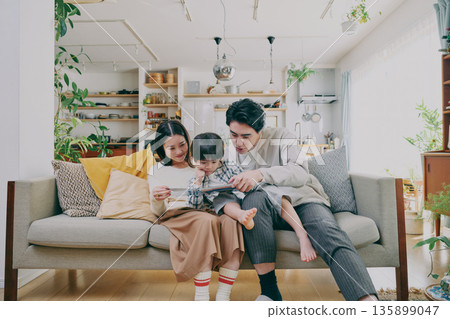 一個家庭在客廳放鬆 135899047