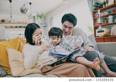 Families reading books in the living room 135899339